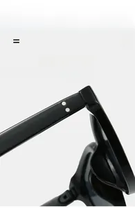 Detail shot of black square sunglasses frame showing silver rivets on the temple hinge