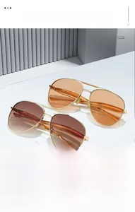 Close-up of classic aviator metal frame sunglasses with orange and brown gradient lenses