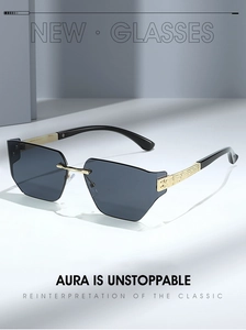 Detail of rimless hexagonal sunglasses with gold engraved temples and dark grey lenses