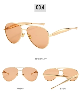 Detail view of gold metal pilot sunglasses with orange lenses showing multiple angles