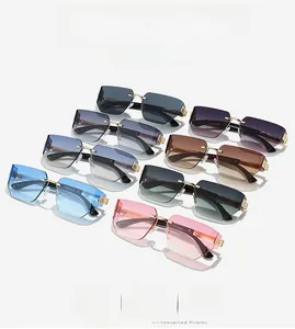 Flat lay of rimless gradient sunglasses in multiple colors with gold metal bridges