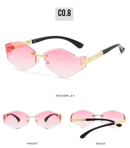 Detail of rimless irregular pink gradient lens and gold engraved metal temples
