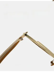 Macro detail of the durable golden metal hinge on these vintage aviator sunglasses