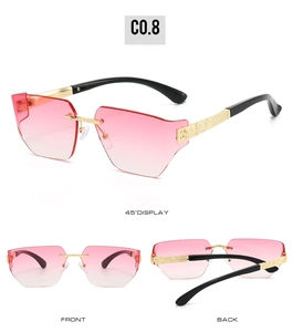 Detail view of pink gradient rimless sunglasses with geometric cut lenses and gold temples