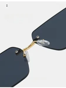Detail of comfortable clear nose pads on rimless sunglasses with gold metal bridge