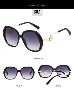 Detailed view of oversized sunglasses with purple gradient lenses and pearl-embellished temples