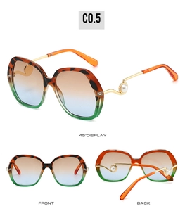 Detailed views of oversized gradient sunglasses with pearl accents on gold metal temples
