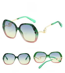 Detailed views of gradient oversized sunglasses with pearl accents and gold metal temples