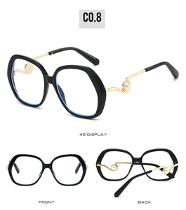 Detail view showing oversized frame sunglasses with elegant pearl accents on gold temples