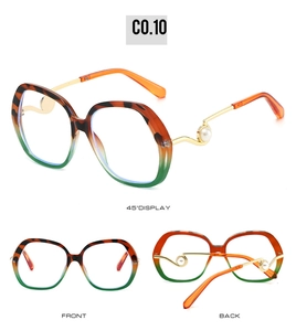Detail of oversized sunglasses with tortoiseshell frames, gold temples and pearl accents