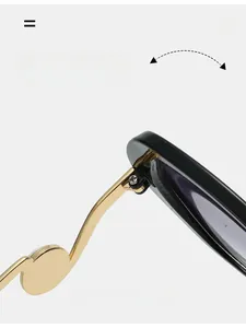 Detail view of durable metal hinges and gold-tone temples on oversized black sunglasses