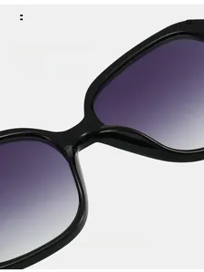 Detail shot of comfortable nose pads on black oversized sunglasses with purple gradient lenses