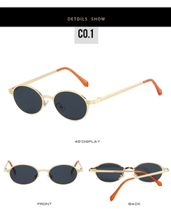 Detail view of oval metal sunglasses with orange temple tips and dark lenses