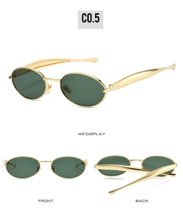 Detail view of oval metal sunglasses with green lenses and wide gold temples