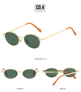 Detail view of oval metal sunglasses with green lenses and orange temple tips