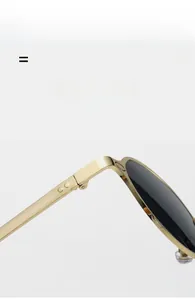 Detail of high-quality golden metal hinge and thin frame on oval sunglasses