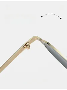 Macro view of durable metal hinges and gold frames of oval vintage sunglasses