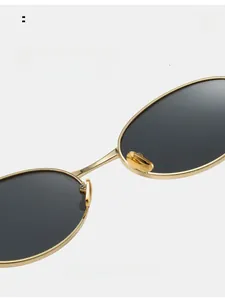 Macro shot of smooth gold metal nose pads and dark lenses on fashion sunglasses