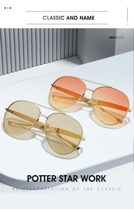 Detail of aviator sunglasses with gold metal frames and gradient orange and yellow lenses
