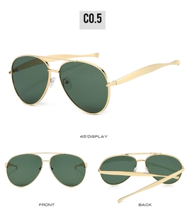 Detail view showing golden metal frame and green lenses of aviator sunglasses