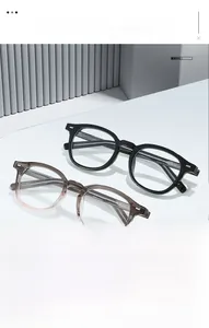 Detail of retro round TR blue light blocking glasses in black and transparent grey