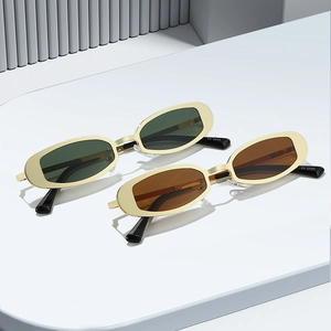 Lunettes de soleil rétro ovales en métal avec verres verts et marron en scène épurée