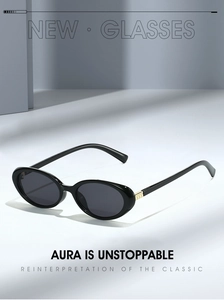 Close-up of retro oval sunglasses with black frames and gold metal hinge accents
