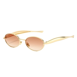 Oval gold metal sunglasses with brown gradient lenses in a minimalist fashion style
