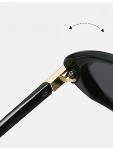 Close-up of durable golden metal hinge on polished black sunglasses temples