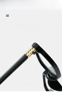 Detail of black eyeglass frame with golden pyramid stud hinge and flexible material