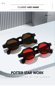 Detail view of vintage thick black frame sunglasses with red and brown tinted lenses