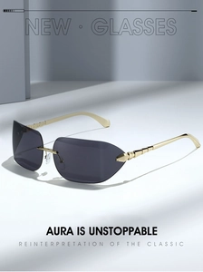 Detail of rimless sunglasses featuring golden tiered metal temples and dark grey lenses