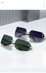 Detail of rimless sunglasses with gradient lenses and elegant golden metal snake temples