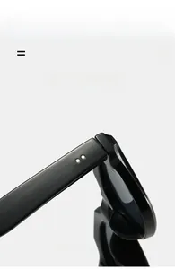 Detail of classic double rivet hinge on black thick frame sunglasses with polished finish
