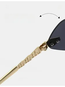 Detail of durable gold metal hinge and textured temples on rimless sunglasses