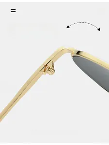Macro shot of durable metal hinge on irregular oversized sunglasses with gold frame