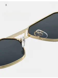 Close-up of comfortable silicone nose pads and golden metal hollow bridge of sunglasses