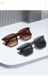 Detail of square PC frame sunglasses with metal rivets and gradient lenses in a minimalist setting