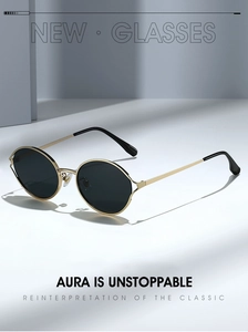 Detail of round black sunglasses with gold metal frame and linear lighting effect