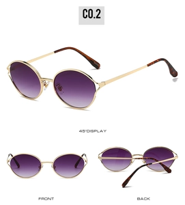 Detail view of gold round frame sunglasses with purple gradient lenses and tortoiseshell tips