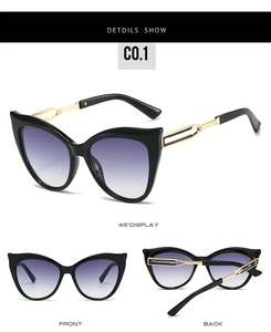 Détail de lunettes de soleil œil de chat avec branches en métal et verres dégradés violets