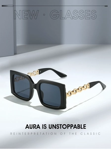 Close-up of square oversized sunglasses featuring chic golden metal chain temples