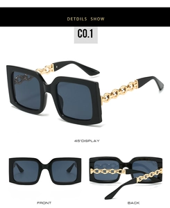 Detail view of large square sunglasses with gold chain temples and dark lenses