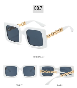 Detailed views of white square sunglasses with bold gold chain temples and grey lenses
