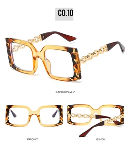Detail view of square tortoiseshell sunglasses with distinctive gold metal chain temples