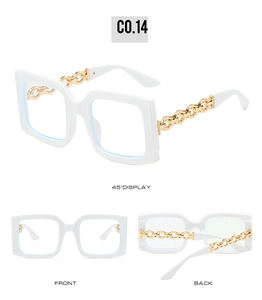 Detail view of white square sunglasses with decorative gold metal chain temples