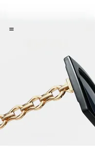Detail of the golden chain temple hinge and black frame of these light square sunglasses