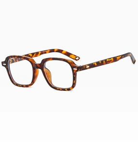 Macro detail of tortoiseshell eyewear frame with silver rivet hinges and square design