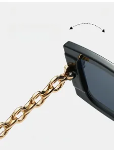 Detail of high-quality metal hinges on black square sunglasses with gold chain temples