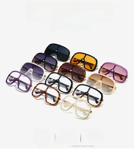 Flat lay of oversized shield sunglasses in 11 colors including tortoiseshell and gradients